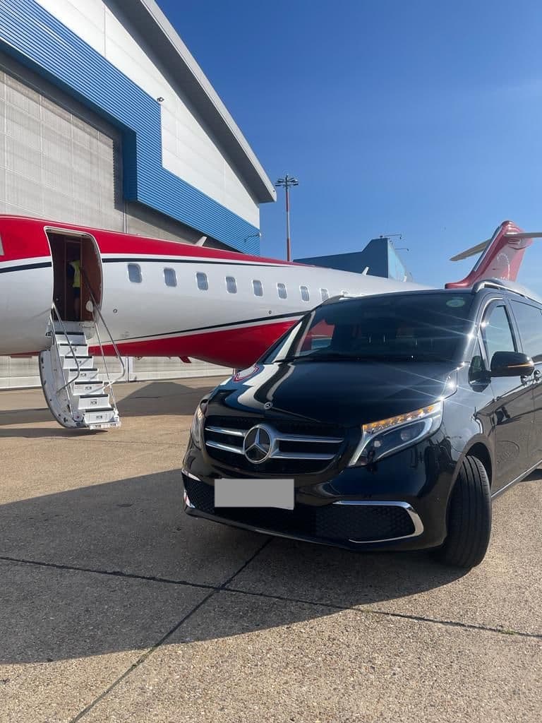 Mercedes V-Class positioned next to private jet stairs